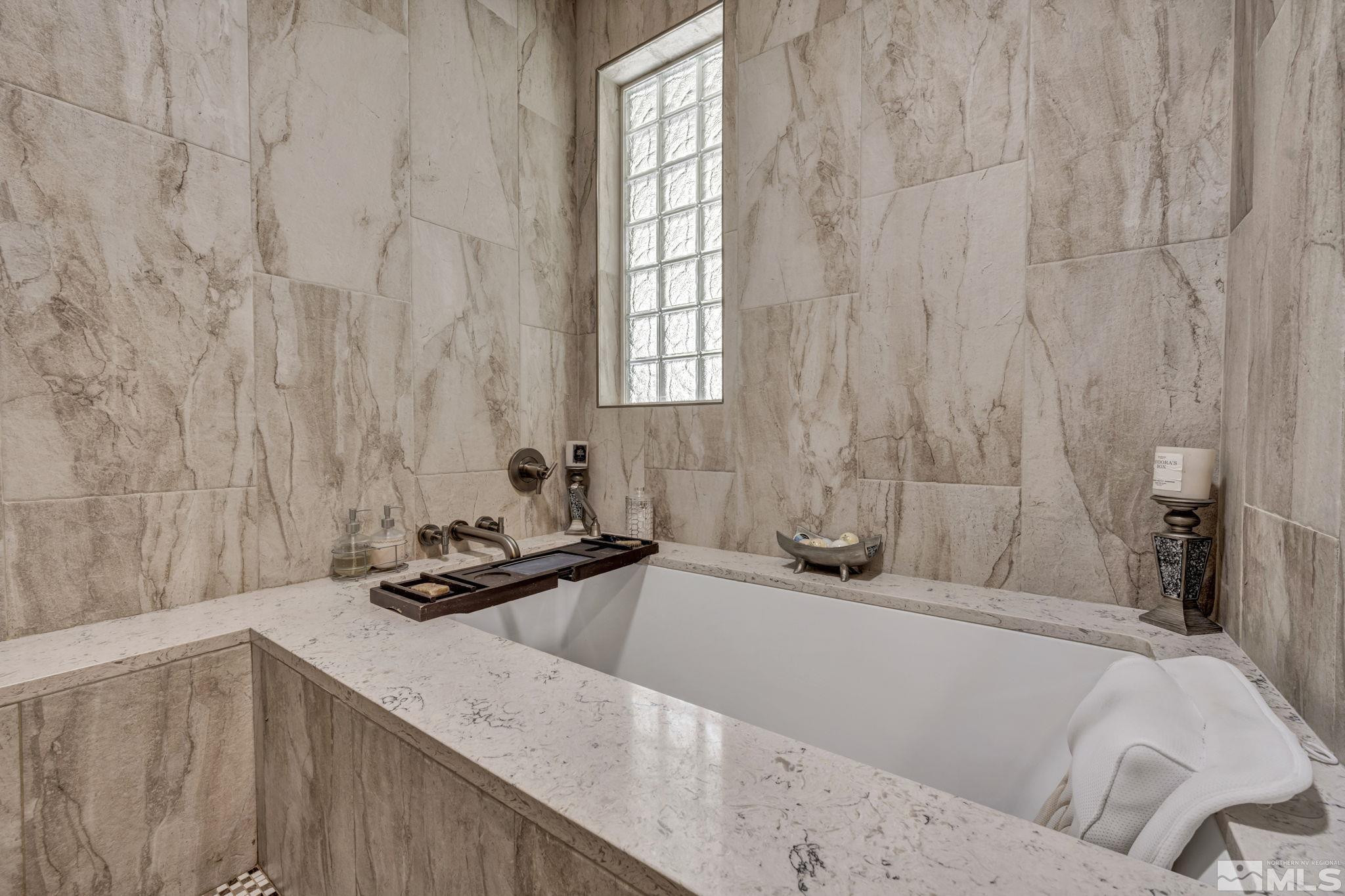 6015 Stillmeadow Drive Reno, NV 89502 - Photo 29 of 39 a bathroom with a granite countertop sink and a bathtub