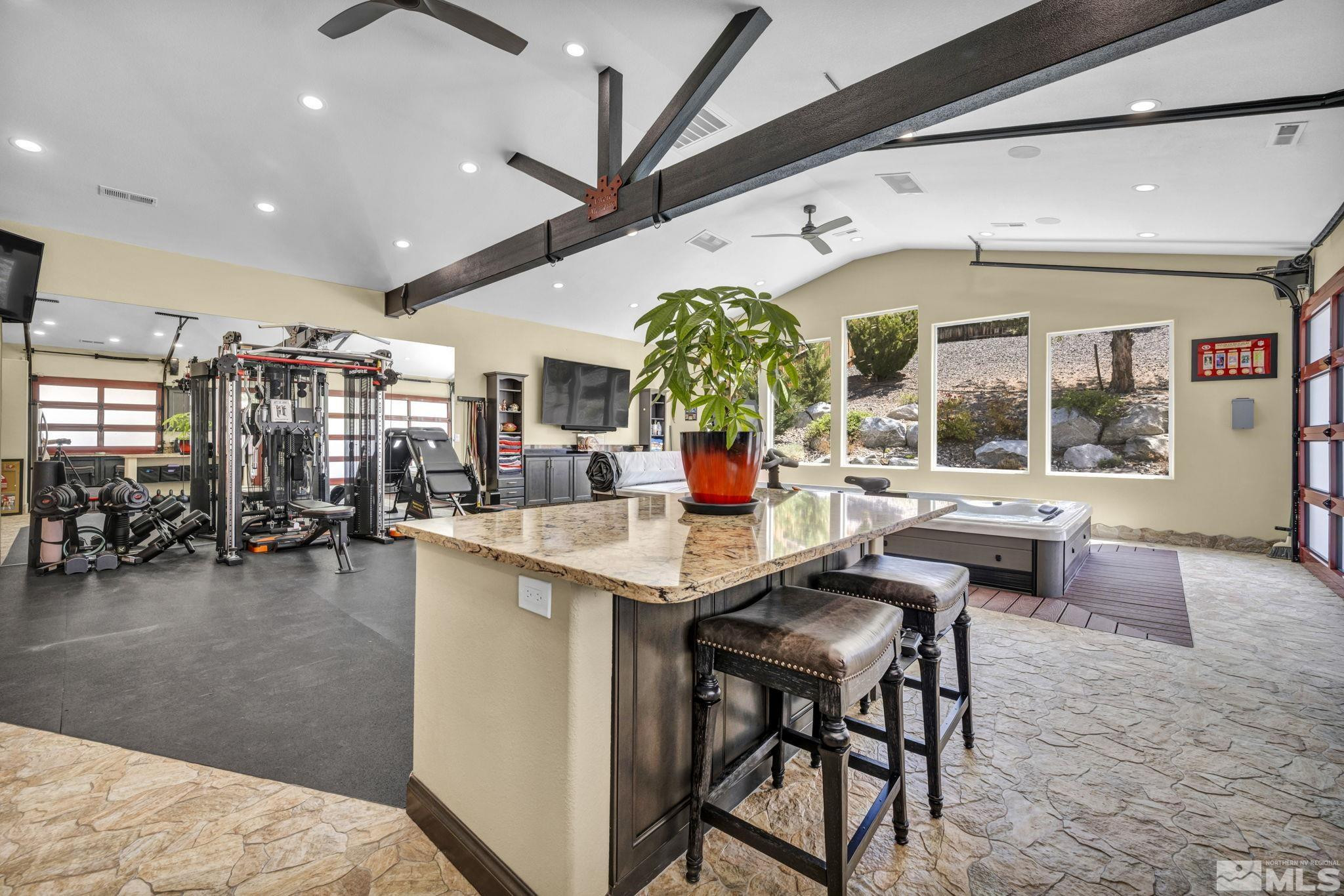 6015 Stillmeadow Drive Reno, NV 89502 - Photo 3 of 39 a kitchen with stainless steel appliances kitchen island granite countertop a table and chairs in it