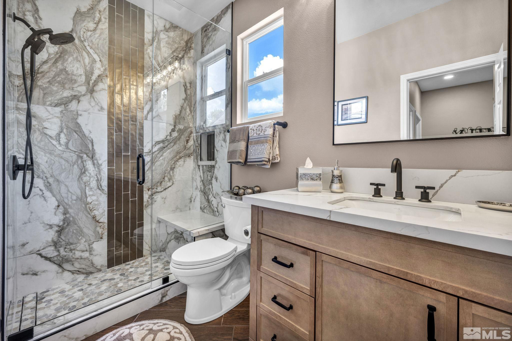 6015 Stillmeadow Drive Reno, NV 89502 - Photo 33 of 39 a bathroom with a granite countertop sink a toilet and a mirror