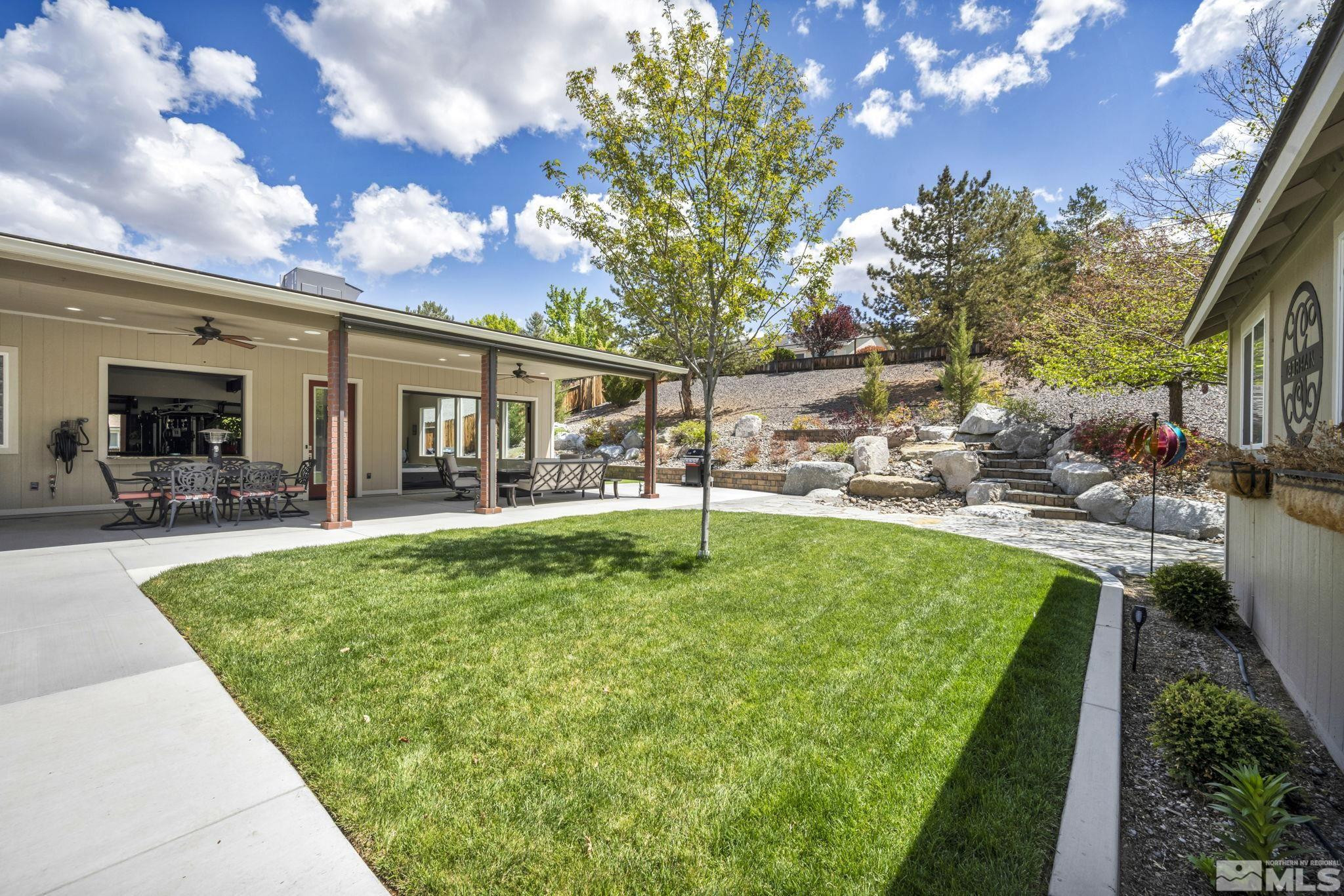 6015 Stillmeadow Drive Reno, NV 89502 - Photo 37 of 39 a view of a patio with table and chairs and potted plants