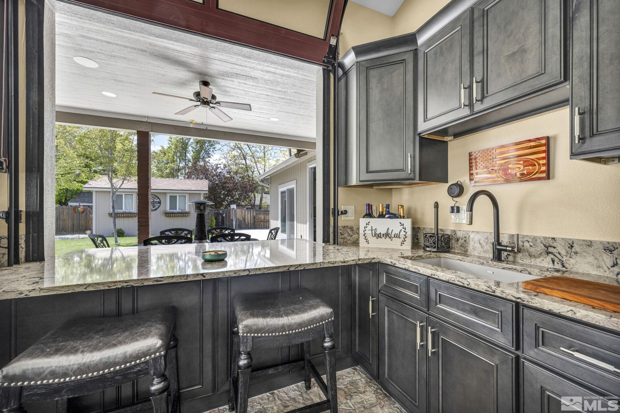 6015 Stillmeadow Drive Reno, NV 89502 - Photo 7 of 39 a kitchen with a sink and a stove