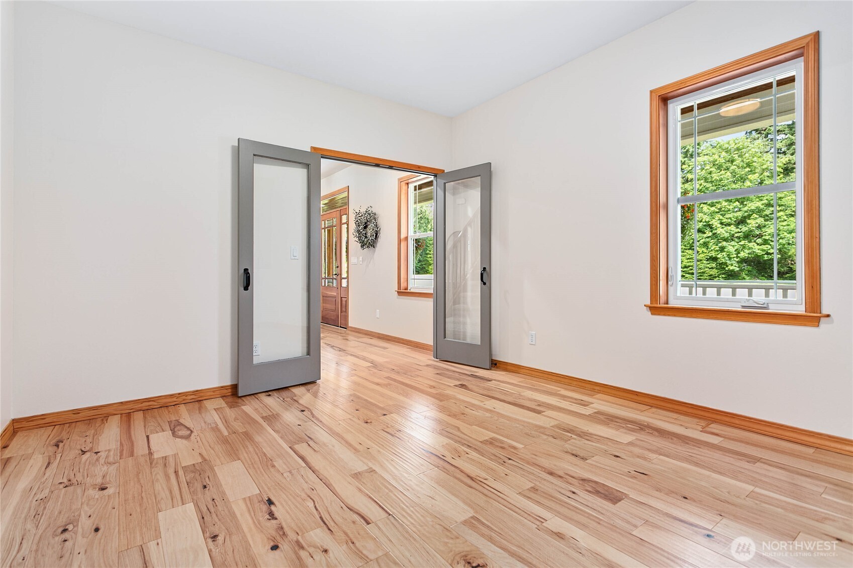 6068 East Hemmi Road Bellingham, WA 98226 - Photo 14 of 40 a view of an empty room with wooden floor and a window