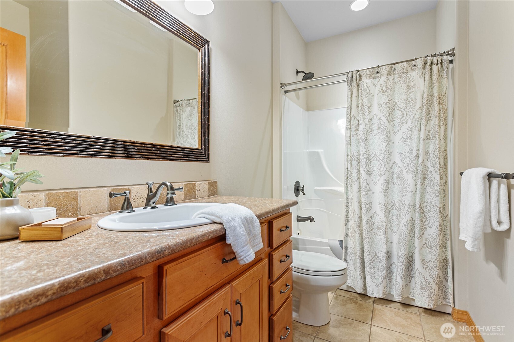 6068 East Hemmi Road Bellingham, WA 98226 - Photo 19 of 40 a bathroom with a granite countertop sink toilet a mirror and shower