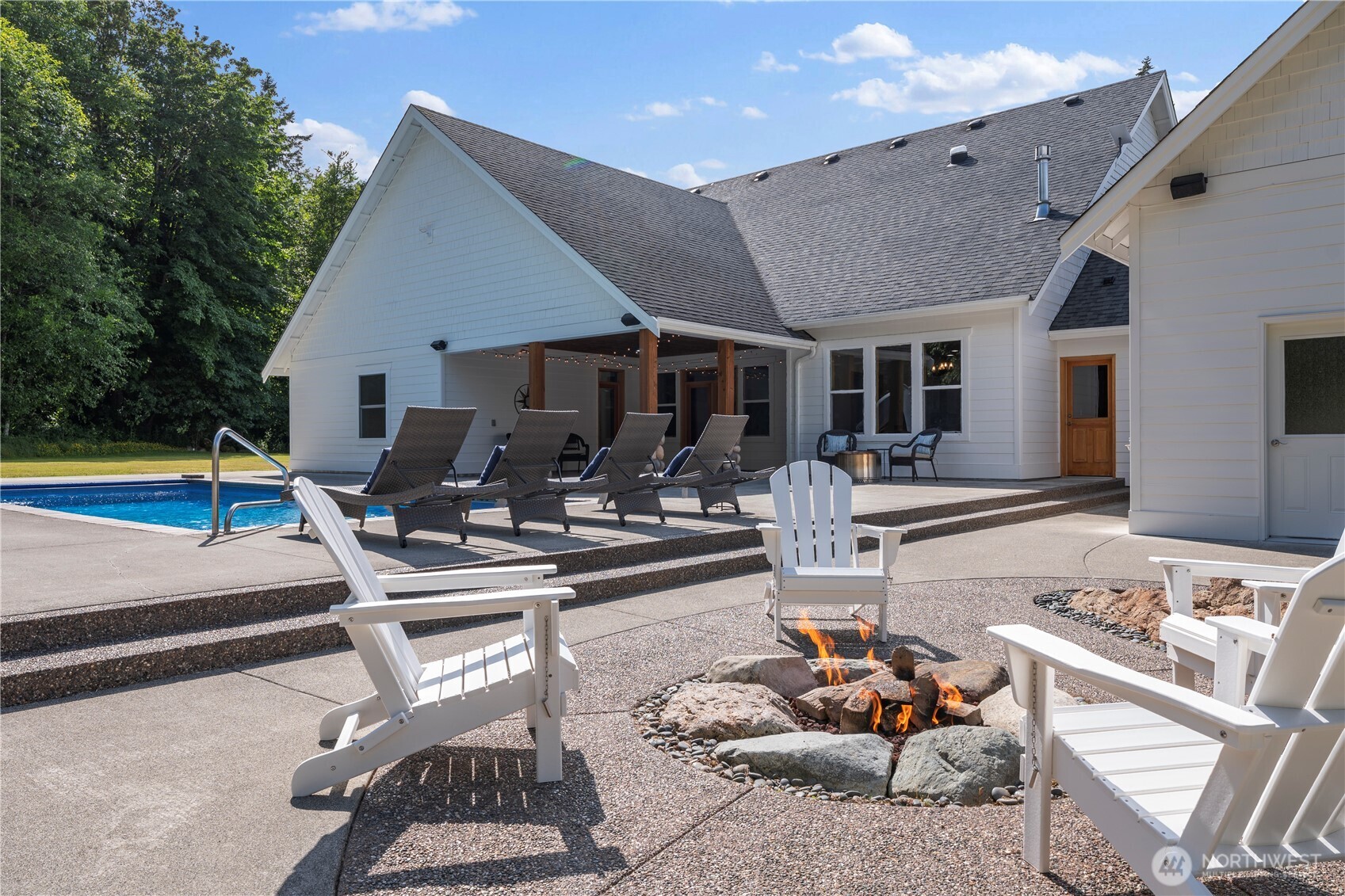 6068 East Hemmi Road Bellingham, WA 98226 - Photo 4 of 40 a view of a patio with couches table and chairs with wooden floor and fence