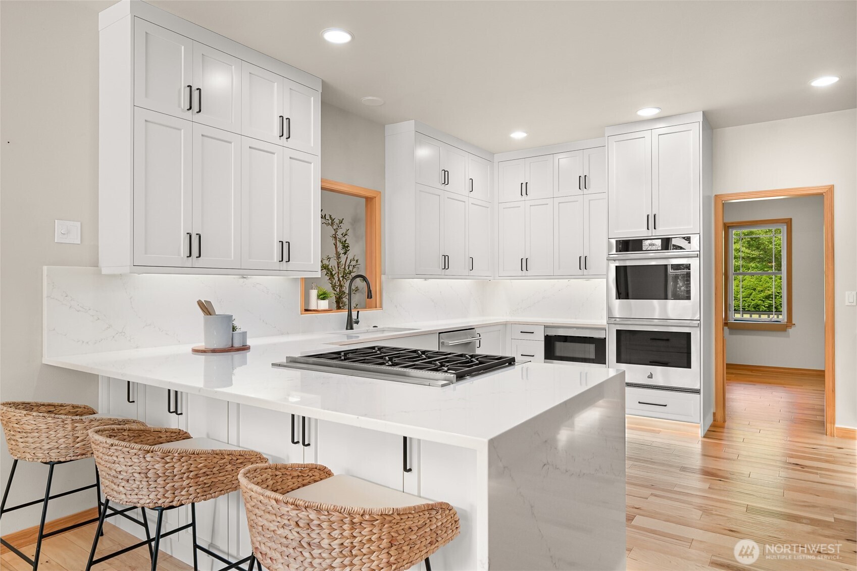 6068 East Hemmi Road Bellingham, WA 98226 - Photo 8 of 40 a kitchen with stainless steel appliances granite countertop a stove top oven a sink a counter space and cabinets