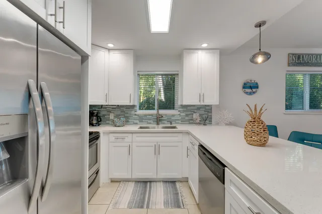 a kitchen with a sink stove and refrigerator