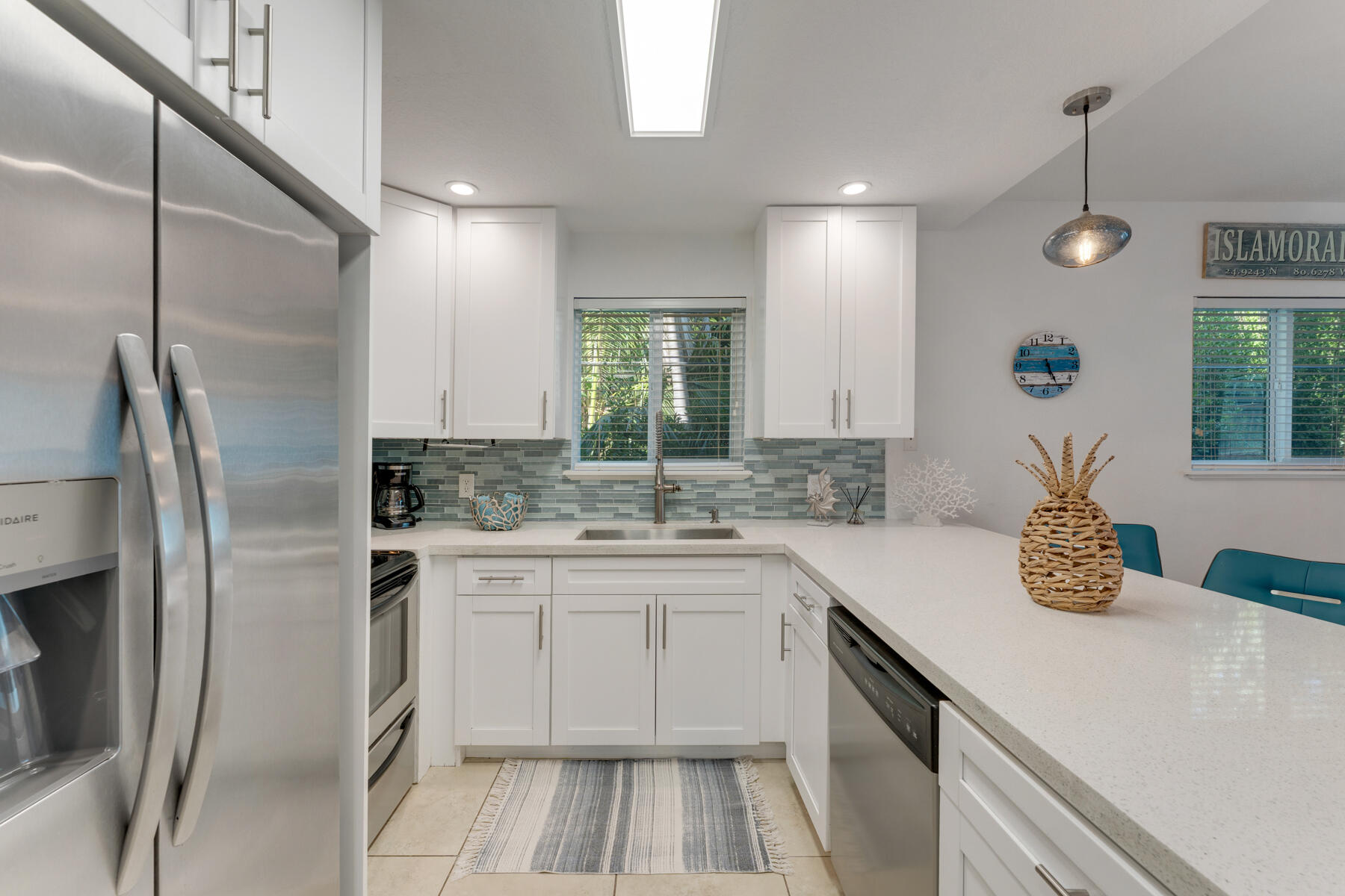 189 Carroll Street Islamorada, FL 33036 - Photo 11 of 37 a kitchen with a sink stove and refrigerator