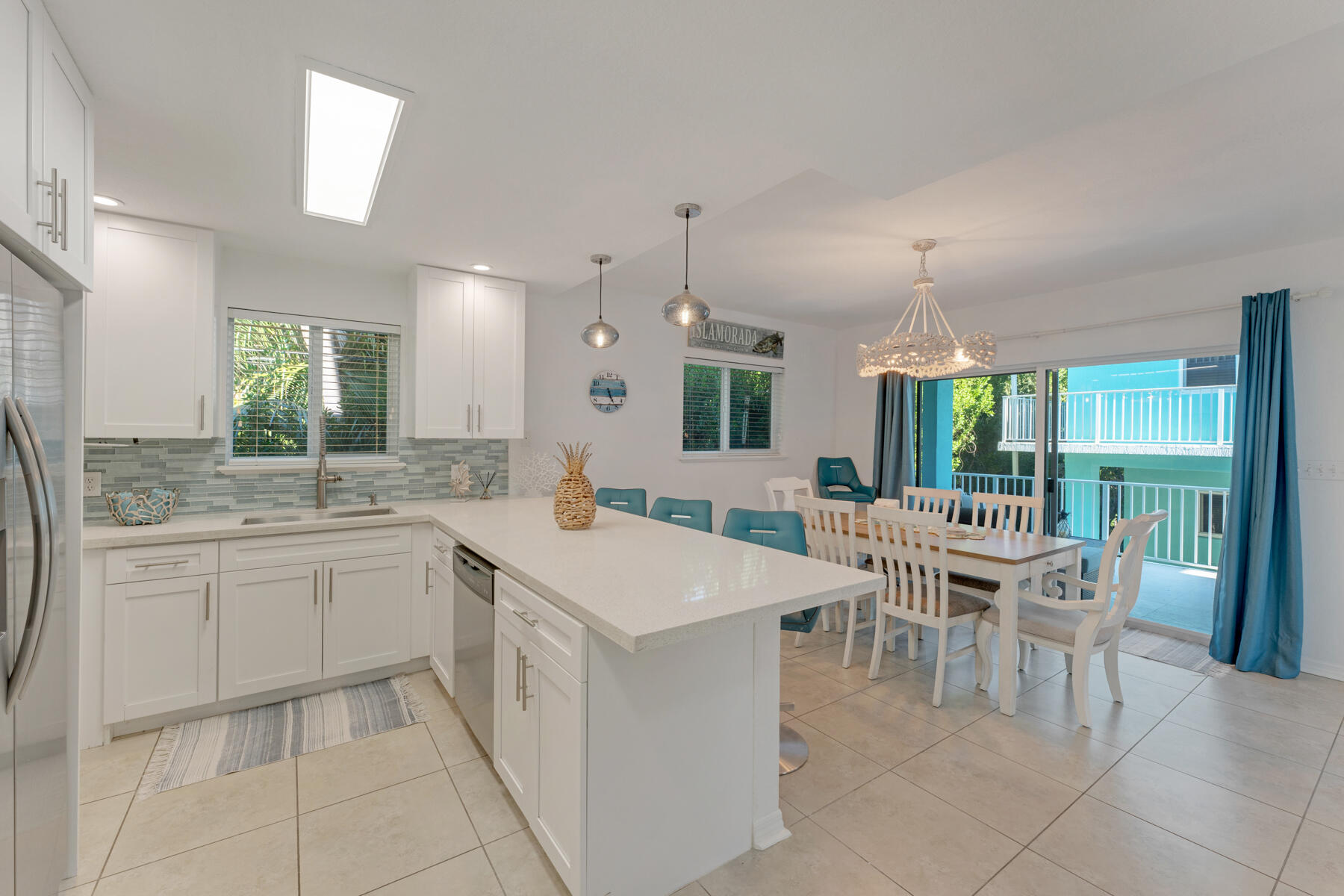 189 Carroll Street Islamorada, FL 33036 - Photo 12 of 37 a large white kitchen with a table and chairs