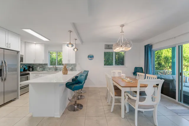 a dining room with furniture a chandelier and window
