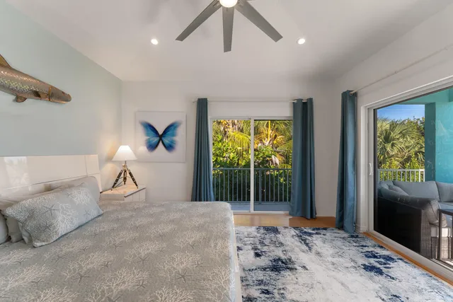a bedroom with furniture and a large window