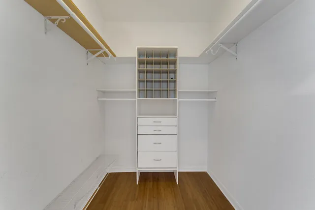 a view of walk in closet with empty racks