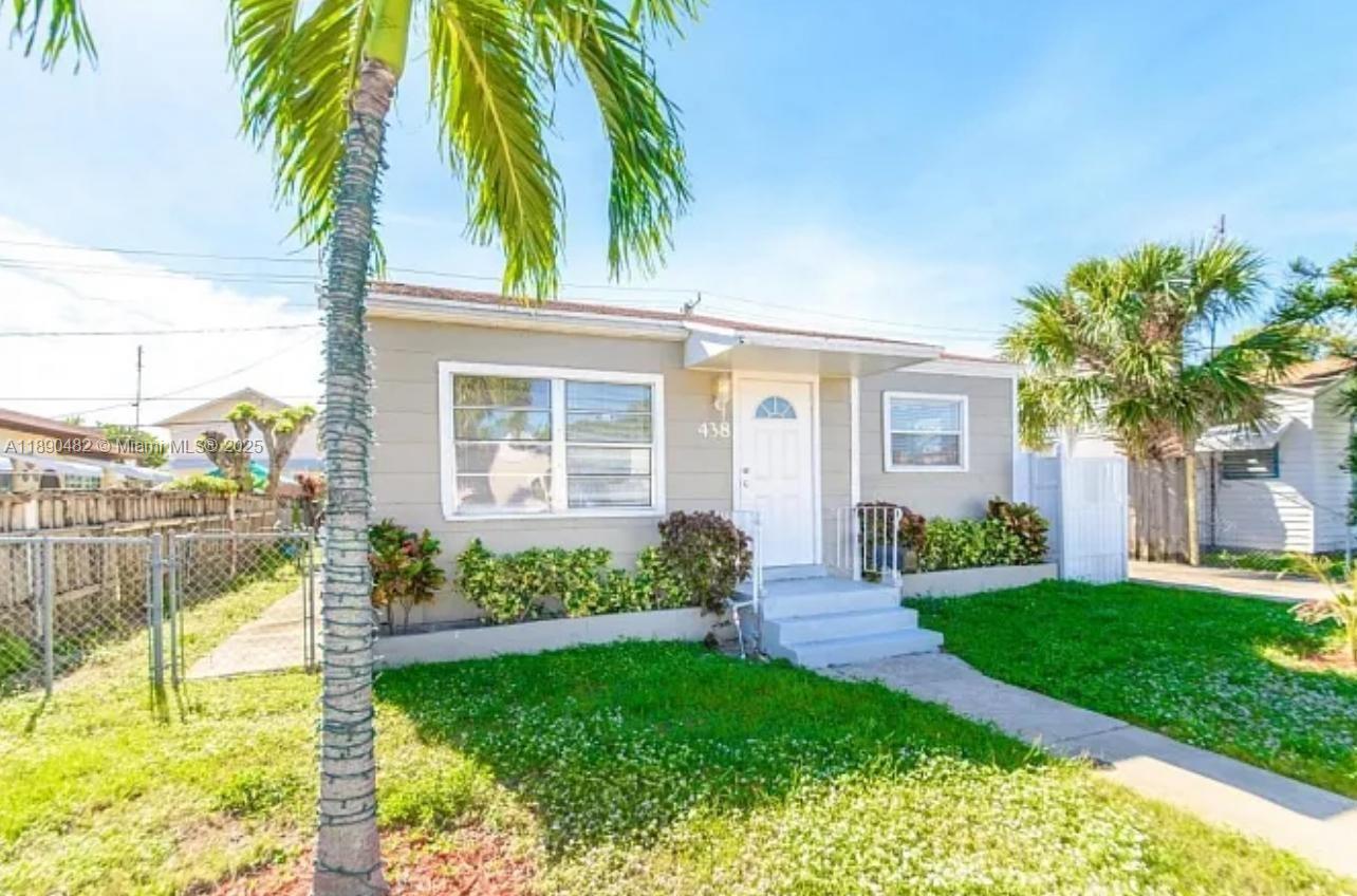 438 Malverne Road, Unit 1 West Palm Beach, FL 33405 - Photo 2 of 12 a view of a house with a yard