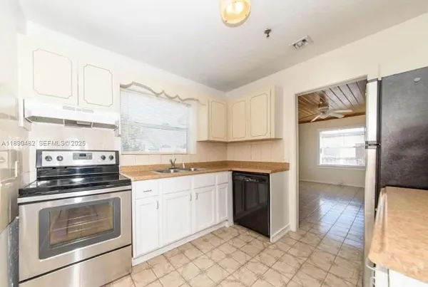 a kitchen with cabinets stainless steel appliances and a counter space
