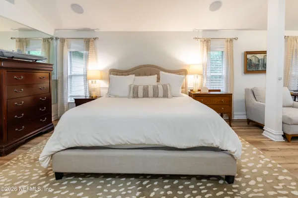 a large bed sitting in a bedroom next to a cabinet