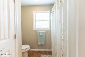 338 Pistole Road Sparta, TN 38583 - Photo 24 of 39 a bathroom with a granite countertop window a toilet and a sink