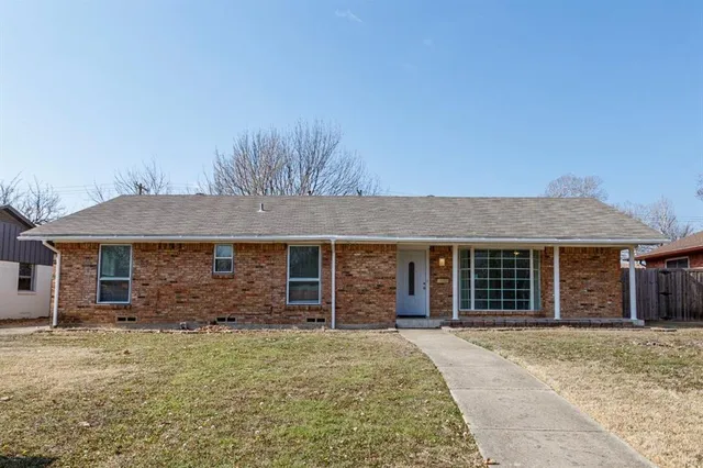 front view of a house with a large yard