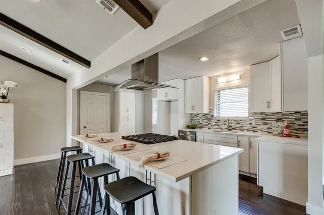 a kitchen with a table and chairs in it