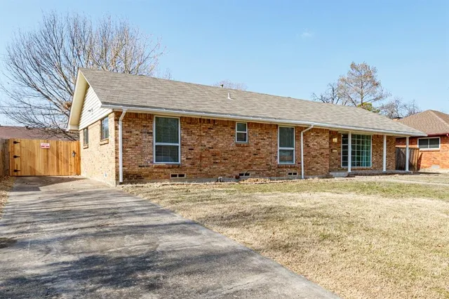a front view of a house with a road