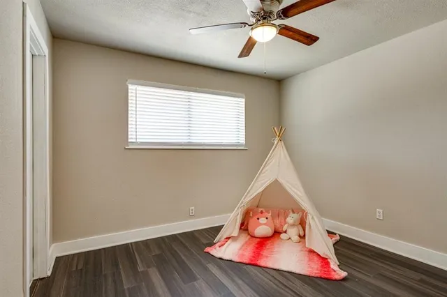 en view of an empty room with window and wooden floor