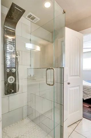 a bathroom with a shower and a sink