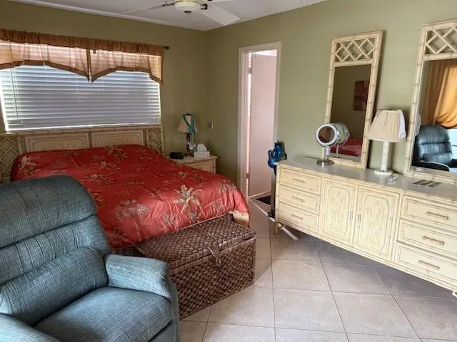 a bedroom with a bed a dresser and mirror