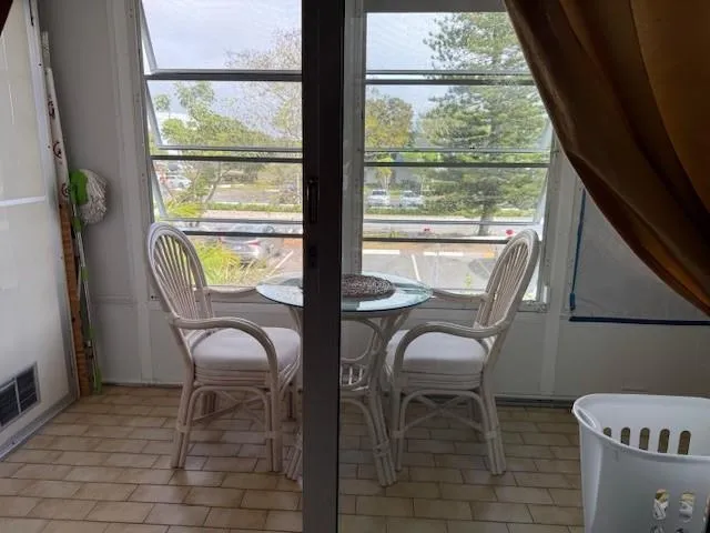 a balcony with table and chairs