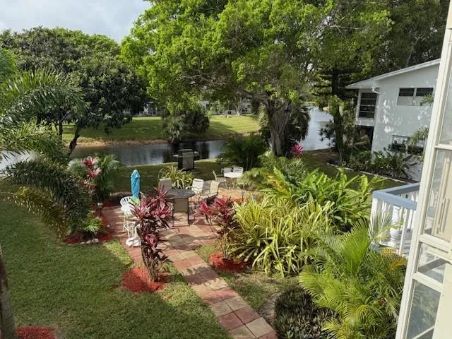 a backyard of a house with yard table and chairs