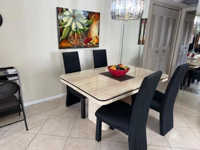 a view of a dining room with furniture and chandelier
