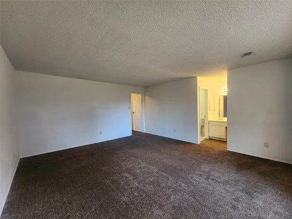 a view of an empty room and a window