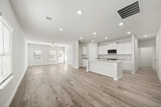 a view of kitchen with granite countertop cabinets and wooden floor