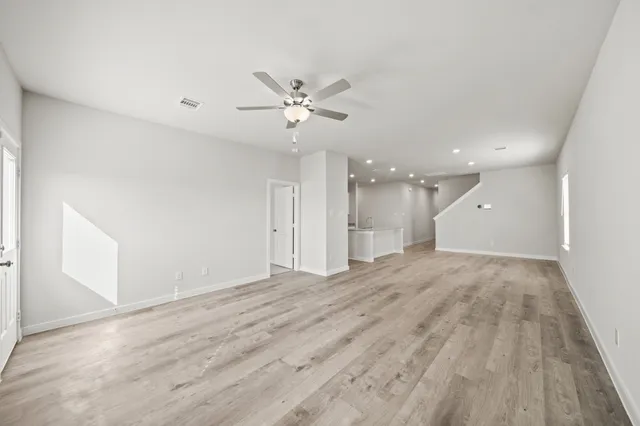 a view of an empty room with a ceiling fan