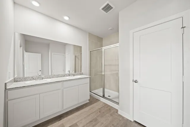 a bathroom with a double vanity sink and mirror