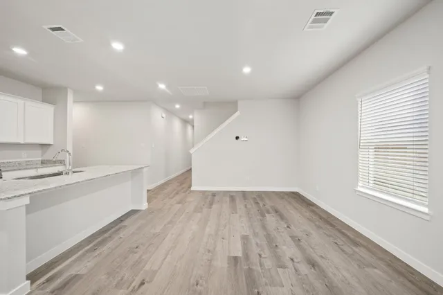 a view of kitchen with sink and wooden floor