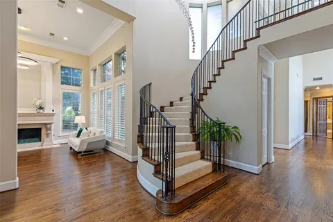a view of entryway livingroom and hall with wooden floor