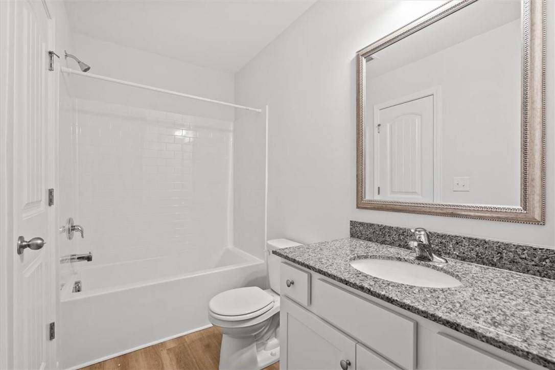 118 Adger Road Pendleton, SC 29670 - Photo 17 of 31 This bathroom features a contemporary vanity with a granite countertop and a sleek, built-in sink.