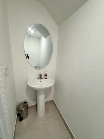 a bathroom with a sink and mirror