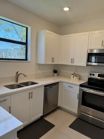 a kitchen with a sink stove and cabinets