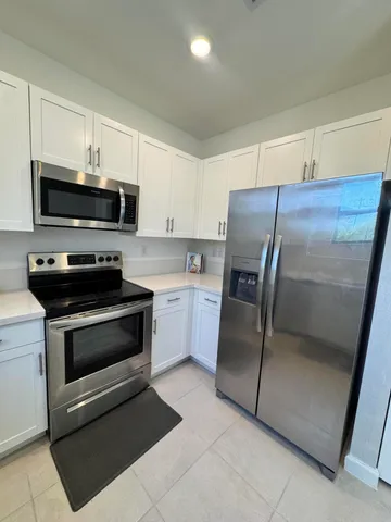 a kitchen with a refrigerator stove and microwave