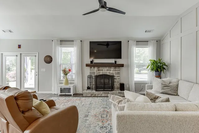 a living room with furniture fireplace and a flat screen tv