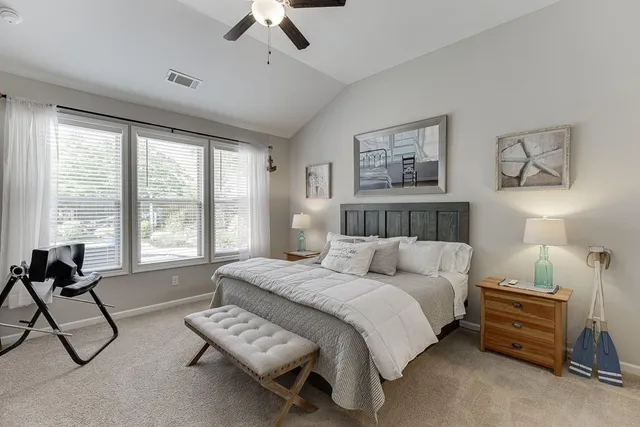 a bedroom with furniture and a large window