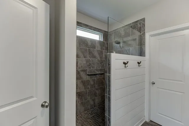 a bathroom with a glass shower door