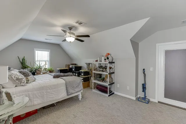 a bedroom with bed and window