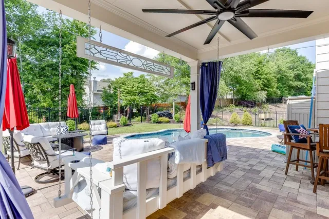 a view of a patio with a table chairs and a porch