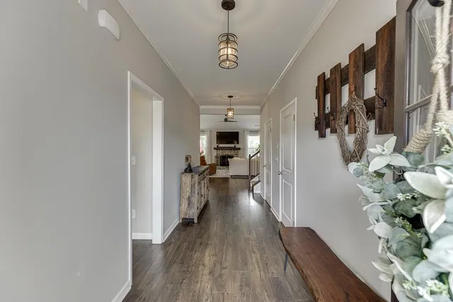 a very nice looking room with wooden floor and a chandelier