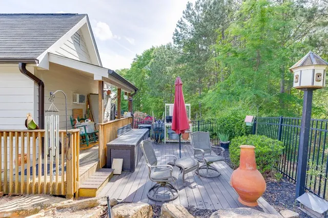 a view of a chairs and table in the backyard
