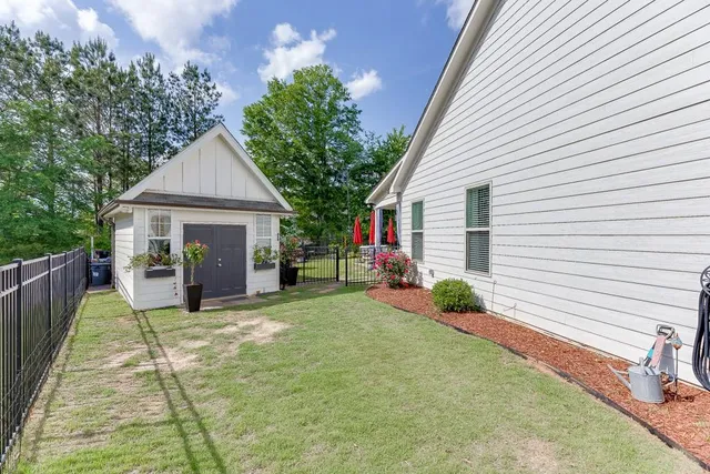 a view of a house with backyard and sitting area