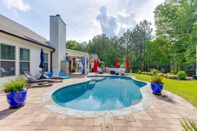 a view of a swimming pool and lounge chairs