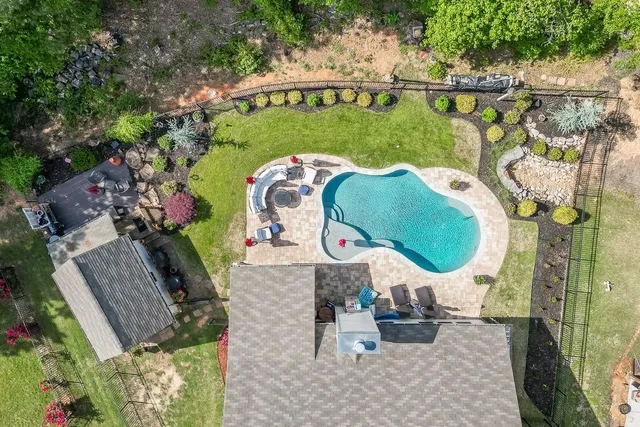 an aerial view of a house with a swimming pool