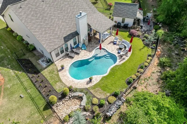 an aerial view of a house with a swimming pool