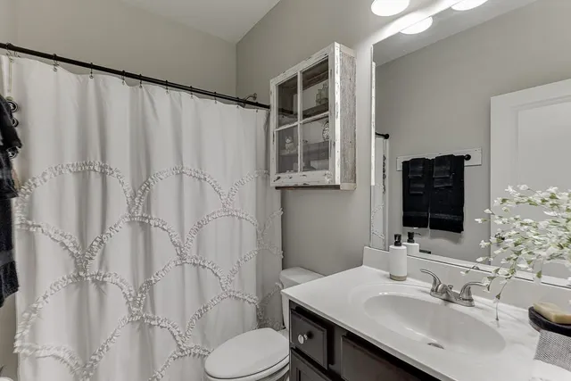 a bathroom with a sink toilet and shower